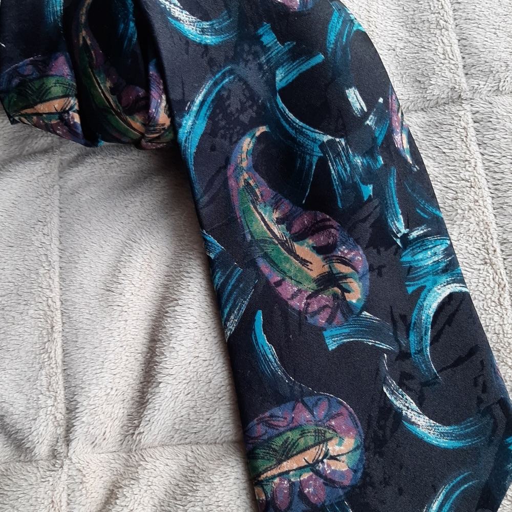 Beautiful black tie with modern design in blue with some pink, beige and…